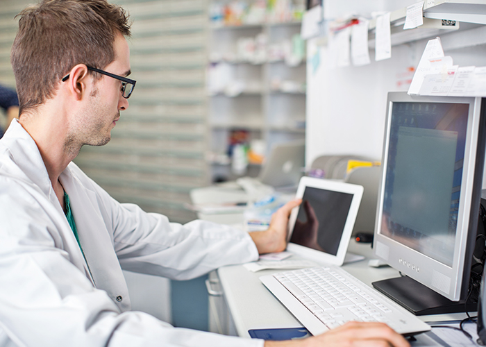 young-male-pharmacist-computer.jpg